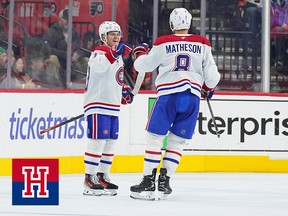 Two hockey players celebrate a goal