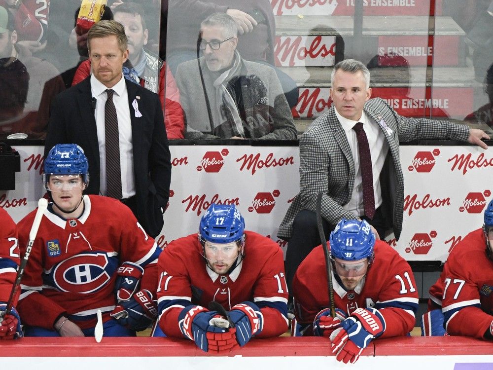 Canadiens head coach Martin St. Louis, right, assistant coach Trevor Letowski, left, and players look on from the bench during third period of Saturday's 6-2 loss to the Golden Knights at the Bell Centre.