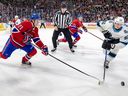 Canadiens' Kaiden Guhle knocks the puck off the stick of Utah Hockey Club's Logan Cooley as Habs Jake Evans provides support in Montreal on Nov. 26, 2024.