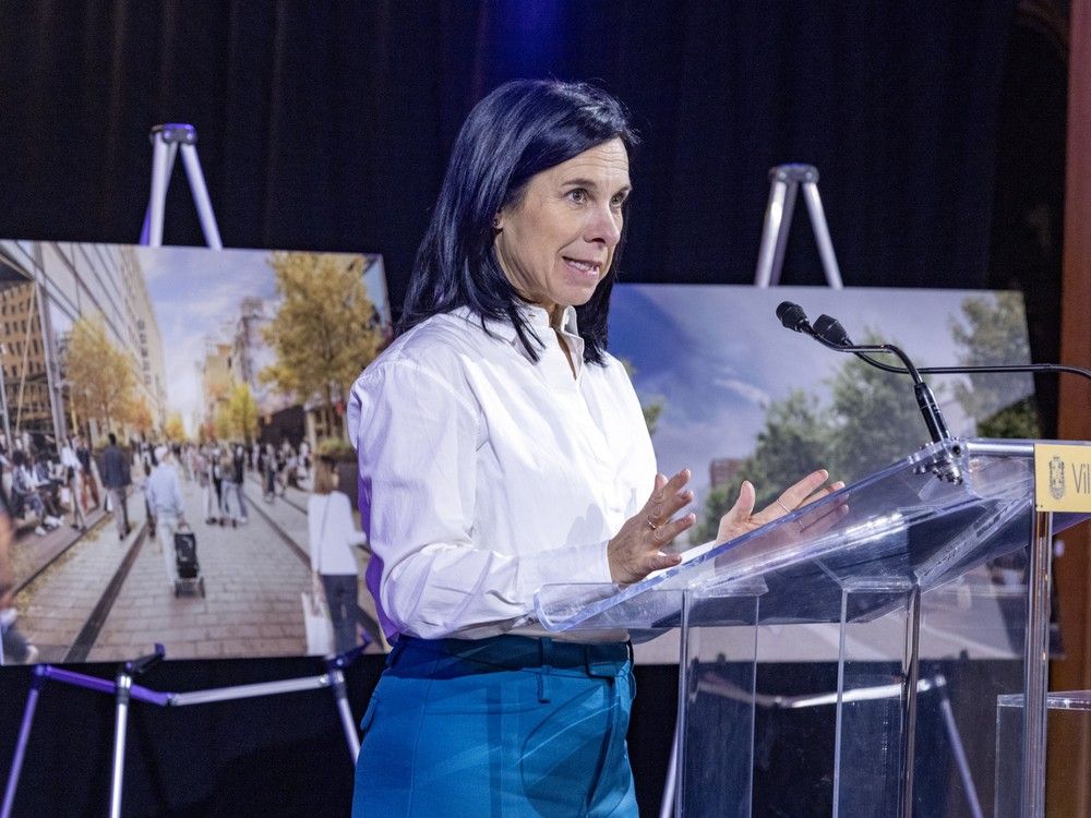 montreal mayor valérie plante speaks in front of two street scenes on easels at a news conference.