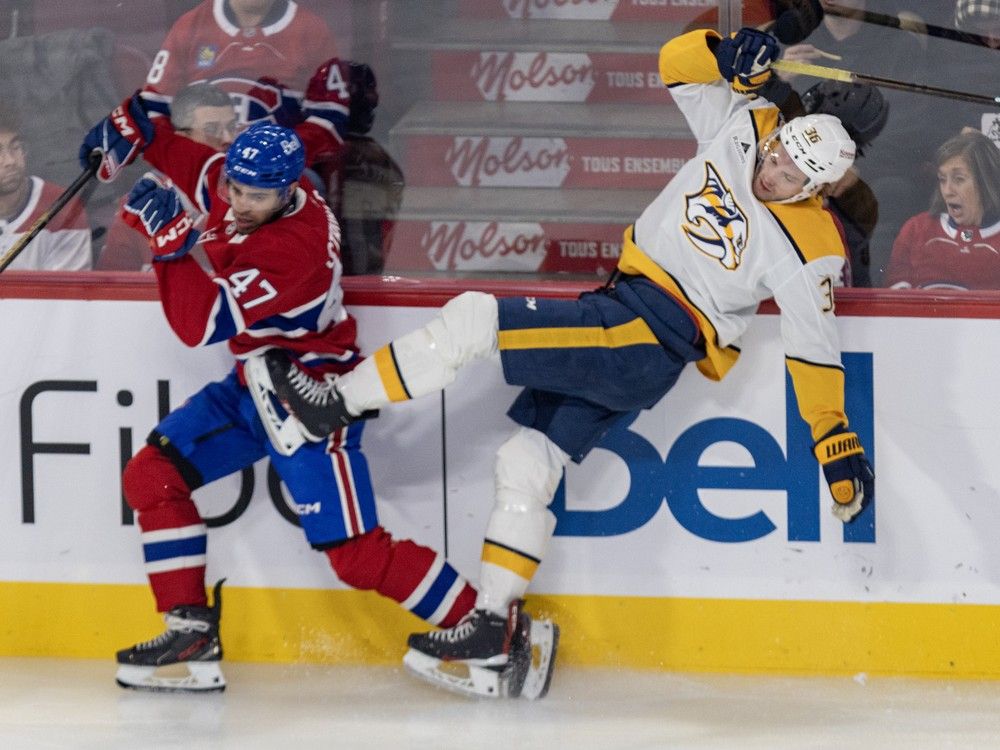 Montreal Canadiens' Jayden Struble knocks Nashville Predators' Cole Smith to the ice along the boards