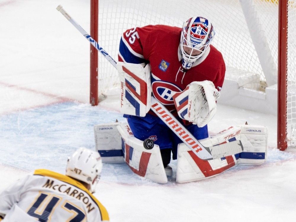 Montreal Canadiens' Sam Montembeault makes a save as Nashville Predators' Michael McCarron closes in