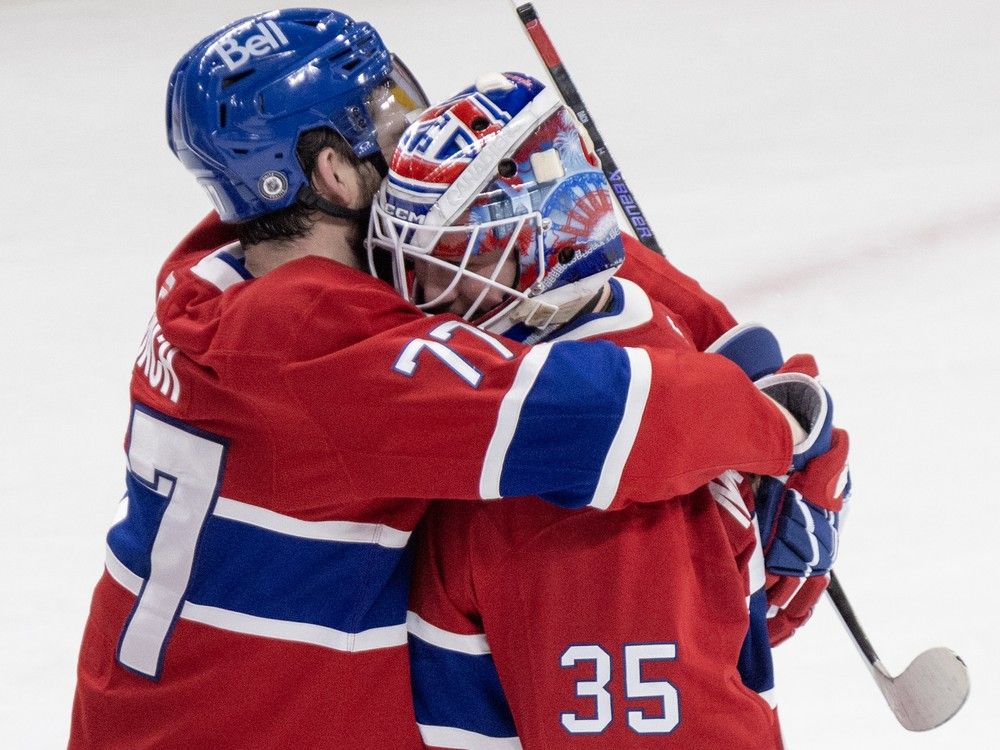Montreal Canadiens' Kirby Dach hugs Sam Montembeault