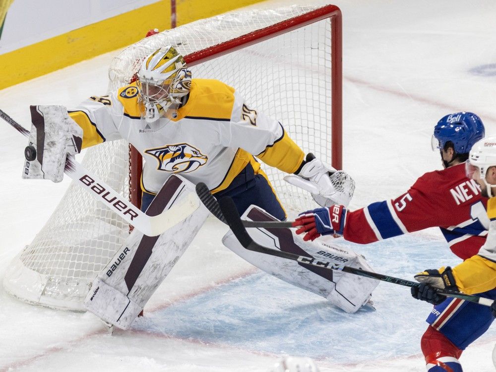 Nashville Predators goalie Justus Annunen makes a blocker save as Montreal Canadiens' Alex Newhook looks for the rebound while being checked by Predators' Alexandre Carrier