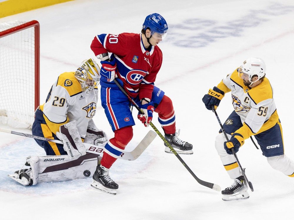 Montreal Canadiens' Juraj Slafkovsky screens Nashville Predators goalie Justus Annunen behind defenceman Roman Josi