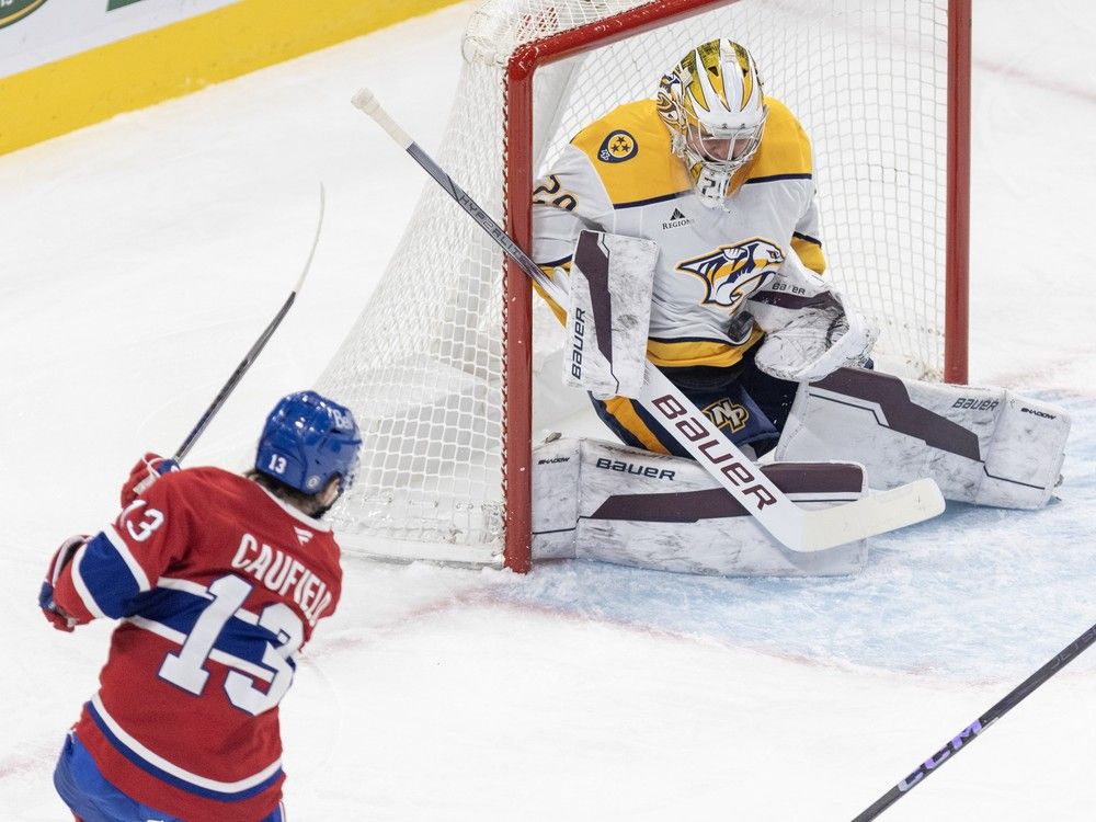 Nashville Predators goalie Justus Annunen makes a save on a shot by Montreal Canadiens' Cole Caufield, who follows through on the side of the net