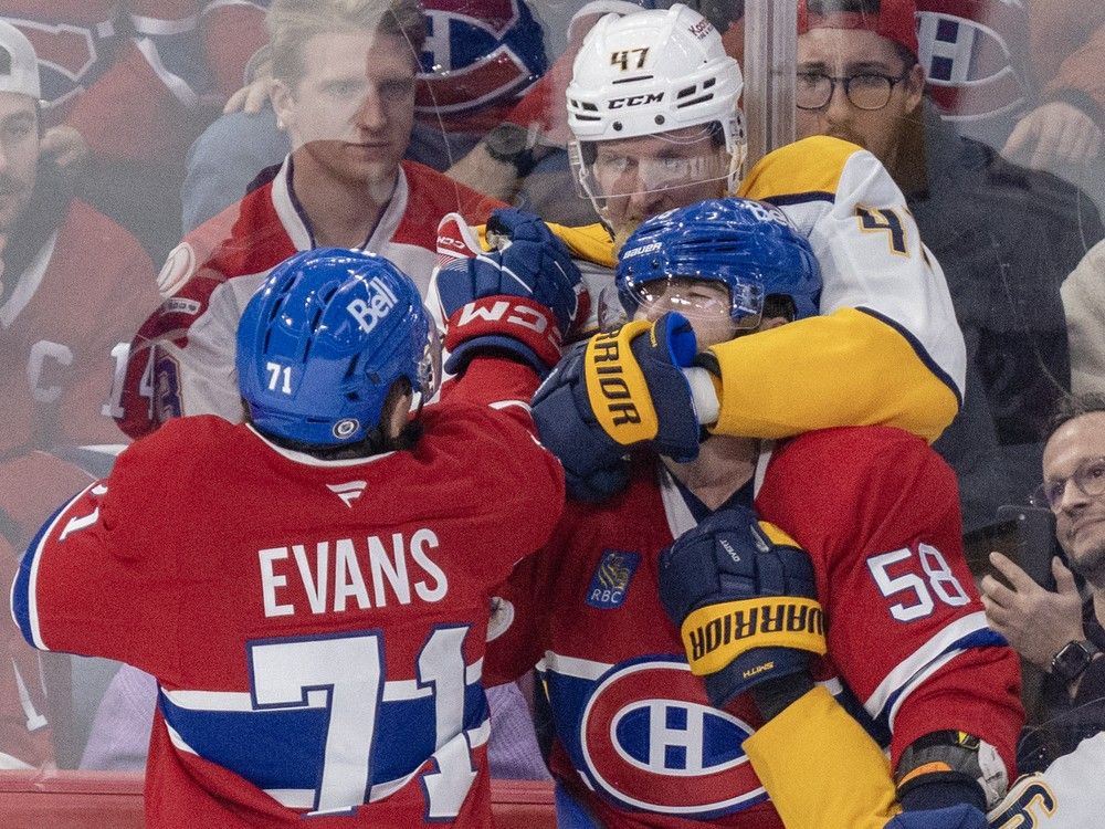 Nashville Predators' Michael McCarron puts Montreal Canadiens' David Savard in a headlock as Jake Evans intervenes