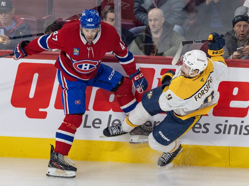 Montreal Canadiens' Jayden Struble knocks Nashville Predators' Filip Forsberg to the ice along the boards