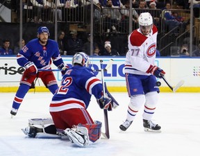 Kirby Dach attempts to control the puck against goaltender Jonathan Quick of the New York Rangers on Saturday.