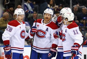 Mike Matheson, second from left, celebrates his first-period goal against the Rangers at Madison Square Garden on Saturday.