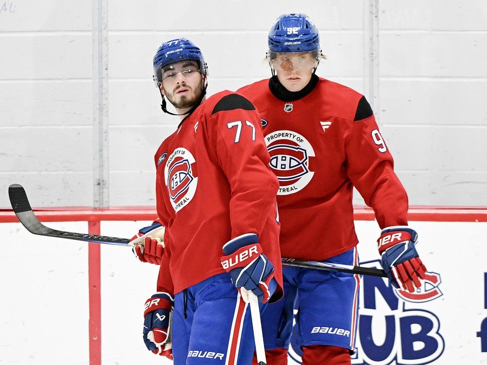  Montreal Canadiens’ Patrik Laine, right, and Kirby Dach look on during training camp session in Brossard on Sept. 18.