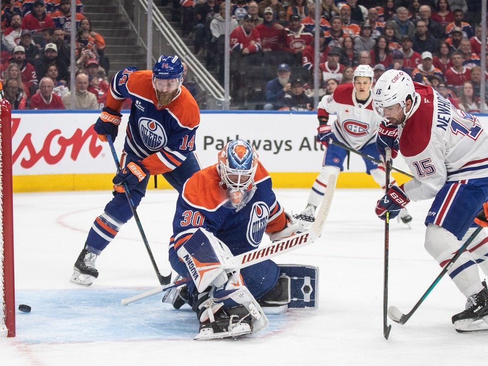 Montreal Canadiens’ Alex Newhook (15) scores on Edmonton Oilers goalie Calvin Pickard (30) as Mattias Ekholm (14) looks on during first period NHL action, in Edmonton on Thursday, October 23, 2025.  Montreal Canadiens’ Alex Newhook (15) scores on Edmonton Oilers goalie Calvin Pickard (30) as Mattias Ekholm (14) looks on during first period NHL action, in Edmonton on Thursday, October 23, 2025.