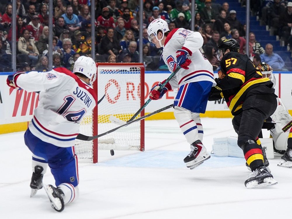 After a feed from Canadiens’ Ivan Demidov, not shown, Habs captain Nick Suzuki scores into an open net behind Canucks goalie Kevin Lankinen as Cole Caufield jumps in front of defenceman Tyler Myers during second period Saturday in Vancouver.  After a feed from Canadiens’ Ivan Demidov, not shown, Habs captain Nick Suzuki scores into an open net behind Canucks goalie Kevin Lankinen as Cole Caufield jumps in front of defenceman Tyler Myers during second period Saturday in Vancouver.