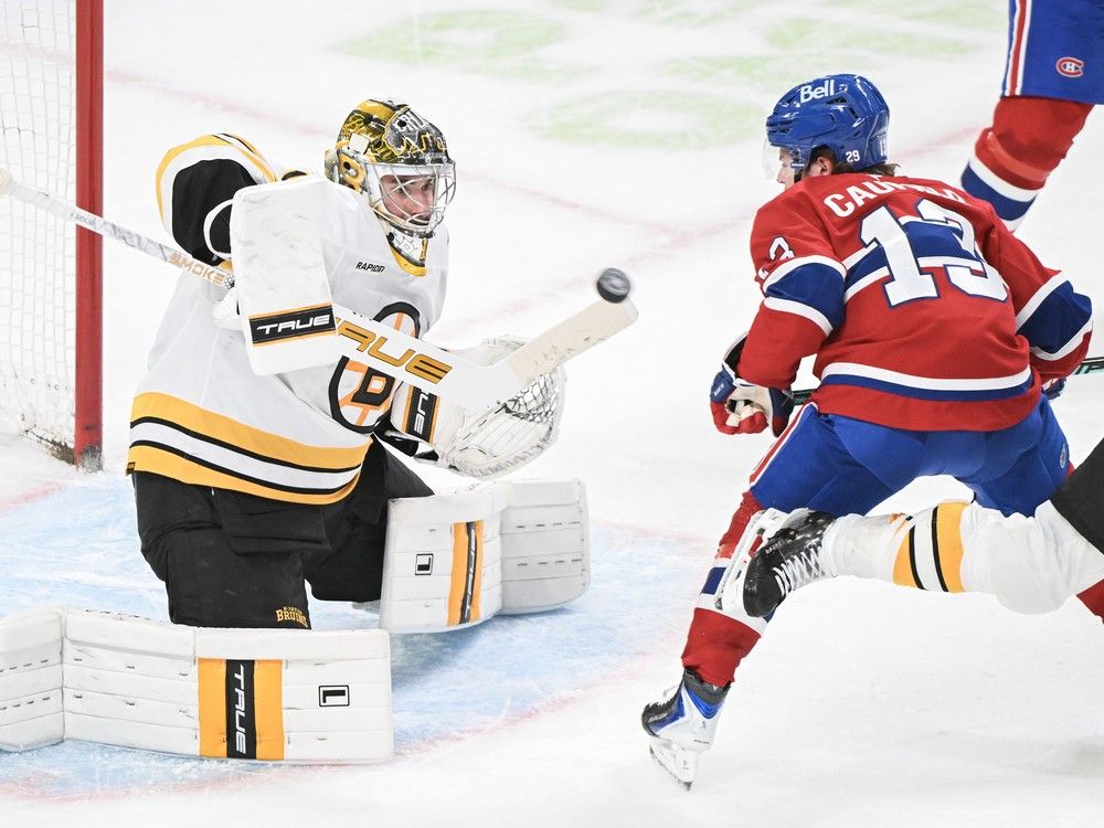 Boston Bruins’ Jeremy Swayman deflects the puck away from Canadiens winger Cole Caufield during third in Montreal on Saturday night. Boston Bruins’ Jeremy Swayman deflects the puck away from Canadiens winger Cole Caufield during third in Montreal on Saturday night.