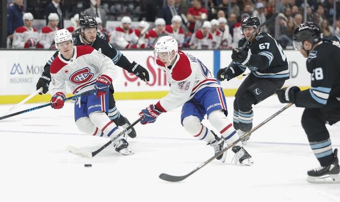  Lane Hutson (#48) and Cole Caufield (#13) of the Montreal Canadiens rush the puck against Lawson Crouse (#67), Ian Cole (#28) and Mikhail Sergachev (#98) of the Utah Mammoth during the first period of their game at the Delta Center on November 26, 2025 in Salt Lake City, Utah.
