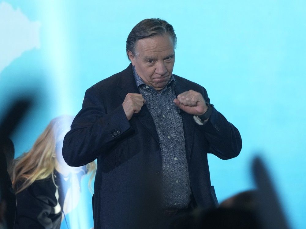  Quebec Premier François Legault takes a boxing stance as he takes to the stage while the theme music from Rocky plays at a CAQ convention in Gatineau Sept. 28, 2025.
