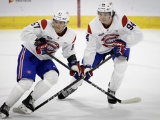 Donato Bracco (57) and Bryce Pickford (94) in white Canadiens practice jerseys on the ice
