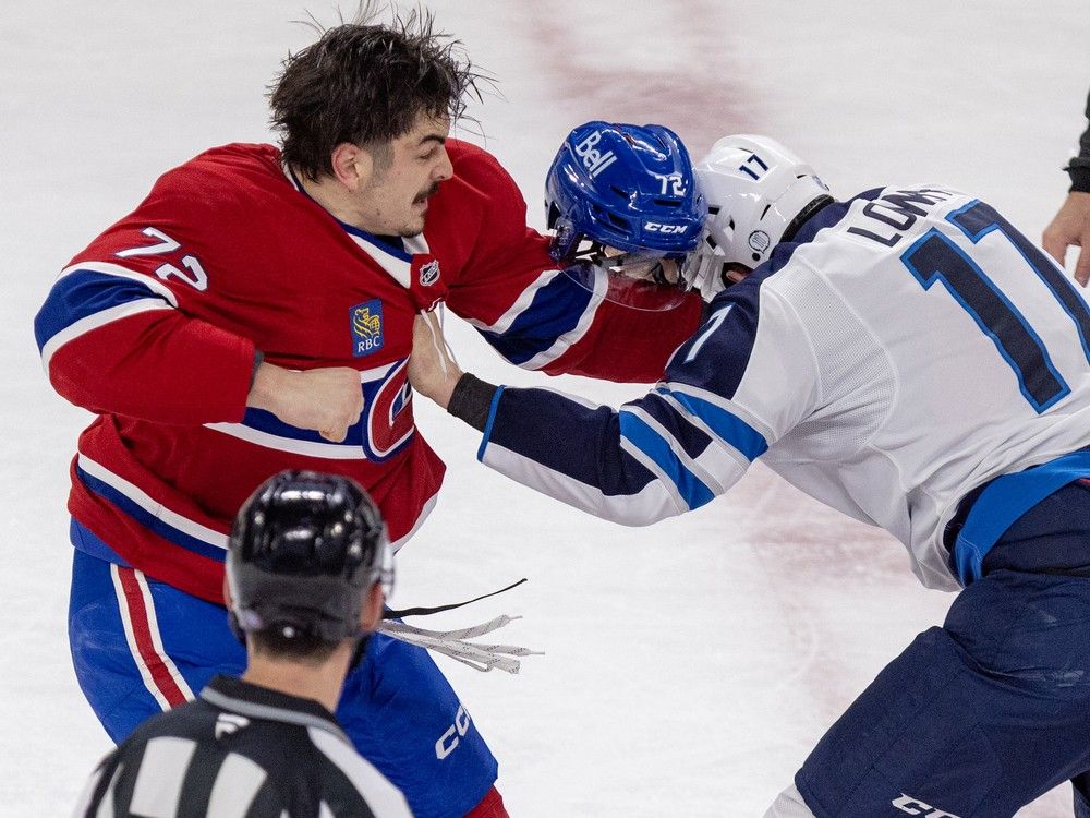  Canadiens’ Arber Xhekaj’s helmet comes off during a fight with Winnipeg Jets’ Adam Lowry during the first period.