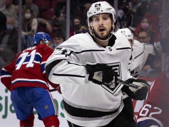 Hockey player skates up the ice.