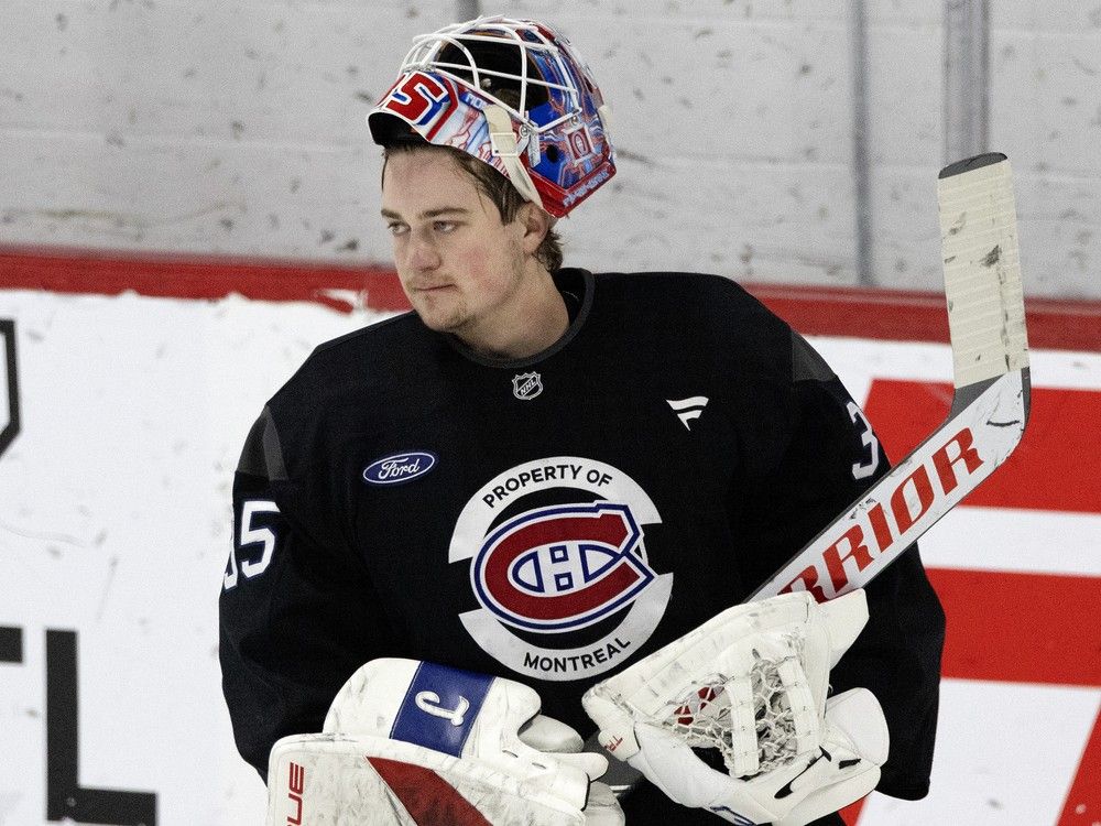 Goalie has his mask flipped up on his head during practice.