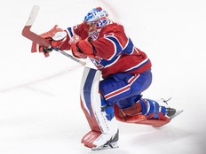 Canadiens goalie Jakub Dobes lunges forward and pumps out his arms after a victory at the Bell Centre.