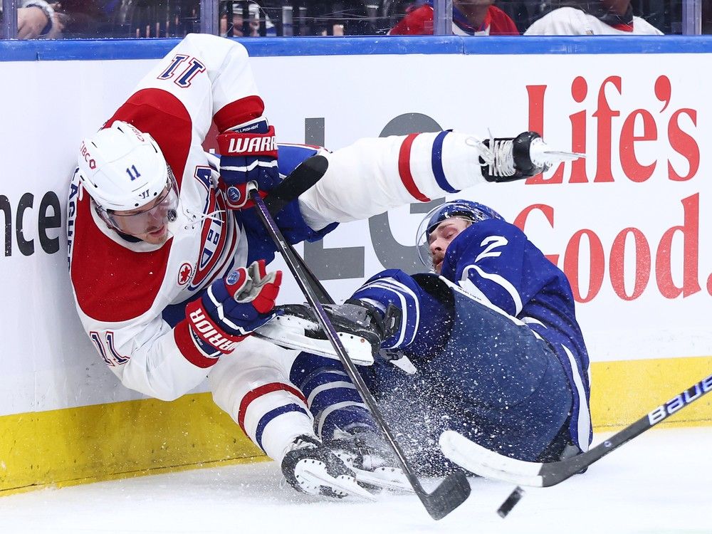  Maple Leafs’ Simon Benoit (2) and Canadiens’ Brendan Gallagher (11) crash into the boards during the first period at Scotiabank Arena on Saturday, Dec. 6, 2025, in Toronto.