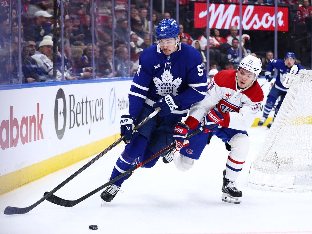  Maple Leafs’ Philippe Myers (51) skates against Canadiens’ Jake Evans (71) during the first period at Scotiabank Arena on Saturday, Dec. 6, 2025, in Toronto.
