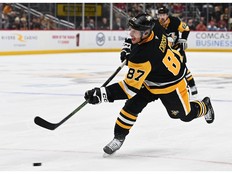 Hockey player steps hard into a shot.