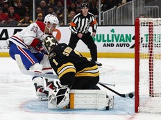 Canadiens' Ivan Demidov scores on Jeremy Swayman of the Boston Bruins. The puck is seen on his stick behind the goalie at the goal line.