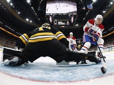 A photo from inside the net shows the puck about to cross the goal line behind the Bruins goaltender