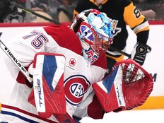 Puck bounces off hockey goaltender's mask.