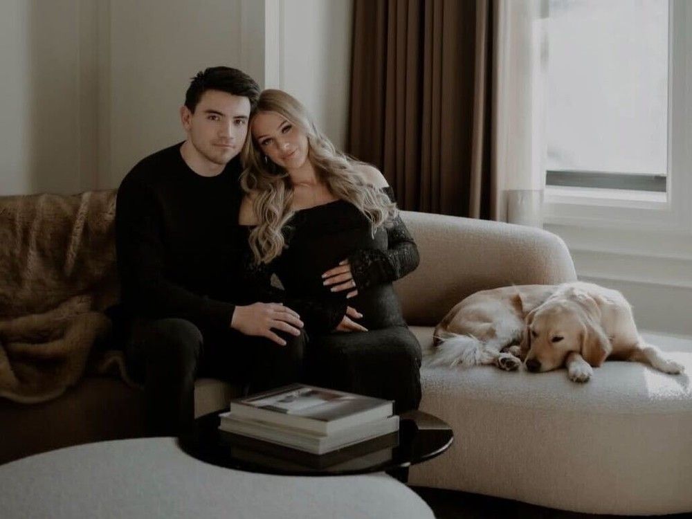 Canadien's Nick Suzuki and his wife, Caitlin Fitzgerald with their dog at home.