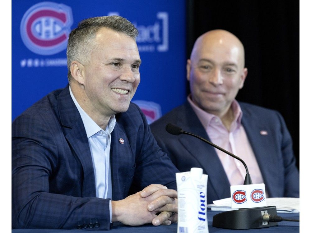  Canadiens general manager Kent Hughes, right, listens as head coach Martin St. Louis speaks during a news conference in Montreal on Feb. 10, 2022.