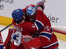 Cole Caufield hugs Jakub Dobes in front of the net