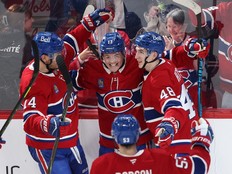 Canadiens players embrace each other along the boards