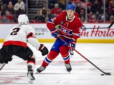Canadiens' Juraj Slafkovsky passes the puck past Ottawa Senators' Artem Zub during third period in Montreal on Dec. 2, 2025.