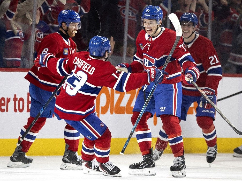  Canadiens centre Jake Evans (71) and right wing Cole Caufield (13) celebrate after Evans scored the winning goal against the Vegas Golden Knights in Montreal, on Tuesday, Jan. 27, 2026.