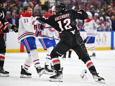 Hockey player shoves an opponent without a helmet.