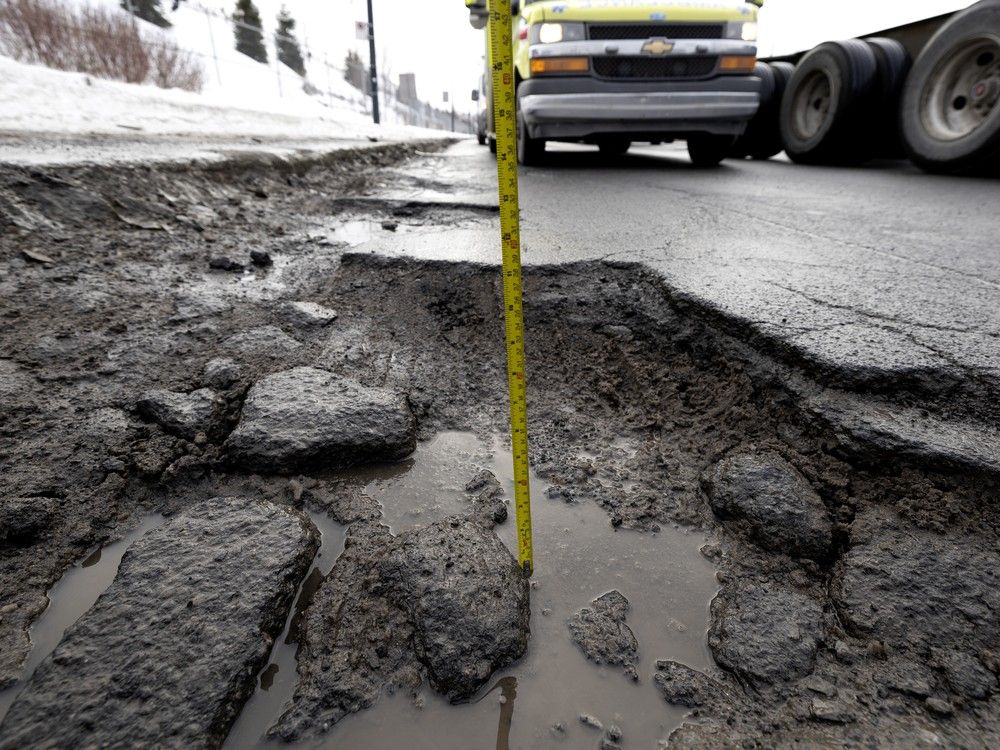 A pothole ranging from eight to 10 inches deep and 54 inches across is seen on Notre-Dame St. near Viau in Montreal, on Tuesday, Feb. 3, 2026.