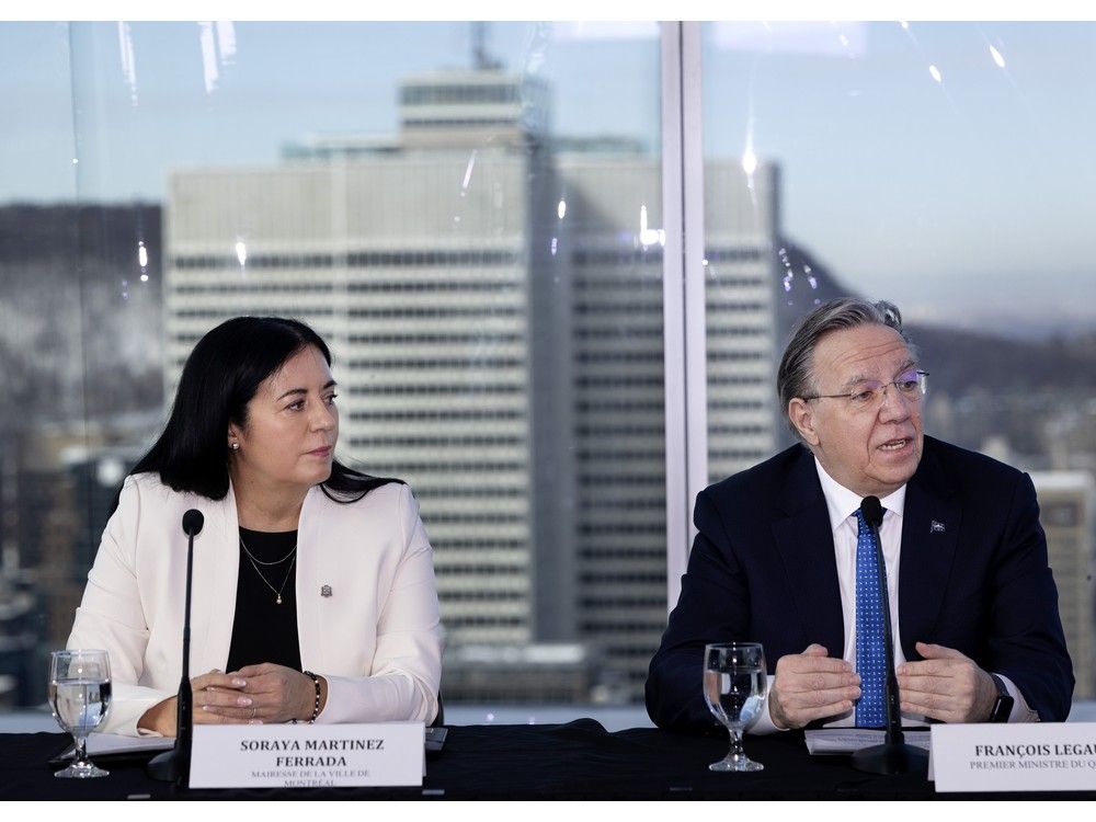 Premier François Legault says the majority of Quebecers have said they're not in favour of separation or holding a referendum, so it would not be an issue for Montreal's eligibility to host a new NATO defence bank. Above: Montreal Mayor Soraya Martinez Ferrada listens as Legault makes a pitch for the city during a presentation at the National Bank headquarters in Montreal on Friday, Feb. 13, 2026.