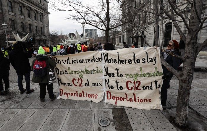 People attend a rally on Saturday, March 7, 2026, beside Montreal City Hall calling on Mayor Soraya Martinez Ferrada to declare Montreal a sanctuary city for people without permanent immigration status. Demonstrators spoke out against Bill C-12, which proposes changes to Canada’s immigration laws and border security.