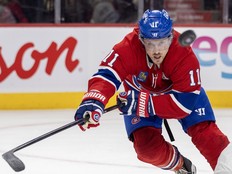 Hockey player concentrates on the puck while skating up the ice.