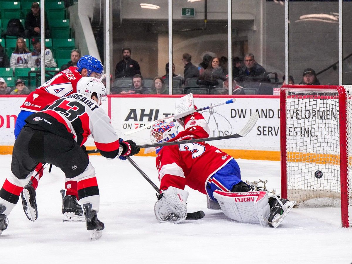 Laval Rocket's Josiah Didier defends as netminder Kaapo Kahkonen surrenders a goal to Belleville Senators' Xavier Bourgault on Dec. 31, 2025, in Belleville.