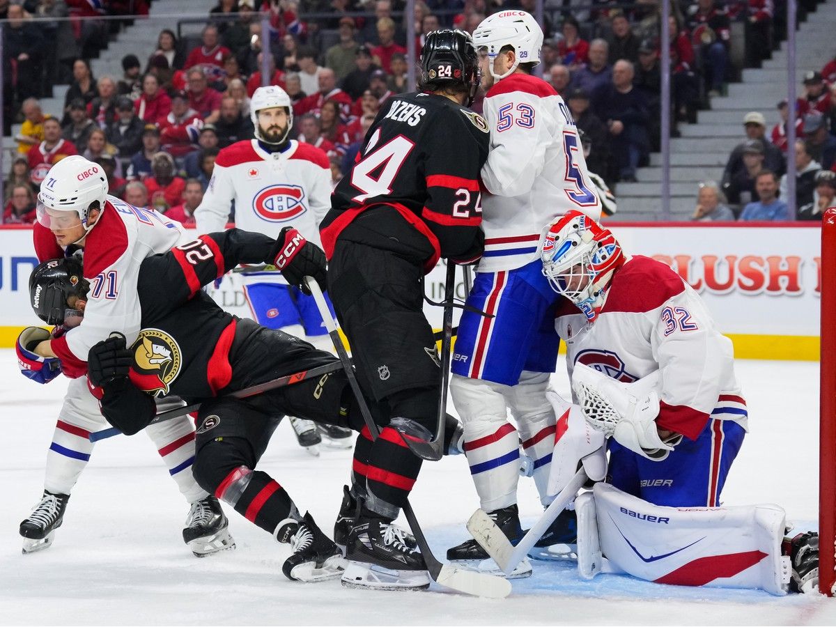 Canadiens forward Jake Evans removes Senators' Fabian Zetterlund from net front as Habs' Noah Dobson and Sens' Dylan Cozens scrum in front of goalie Jacob Fowler during second period in Ottawa on Wednesday.