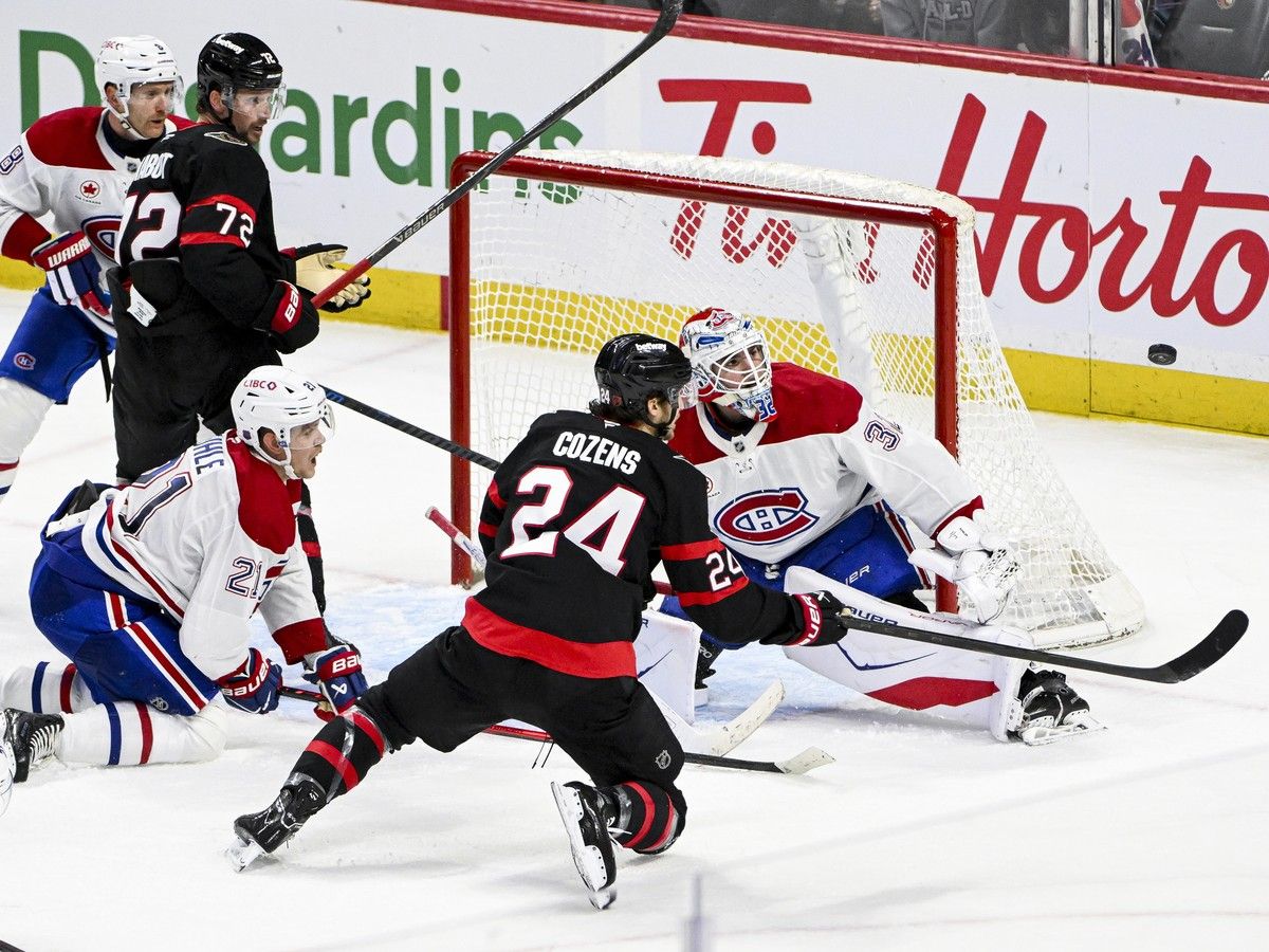Canadiens goaltender Jacob Fowler tracks the puck as Senators' Dylan Cozens falls to the ice during third period in Ottawa on Wednesday.