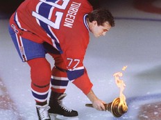 Canadiens captain Pierre Turgeon touches torch to Molson Centre ice before the team's first game at the arena in Montreal on March 16, 1996.