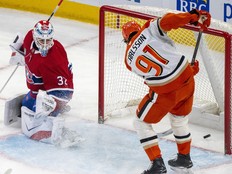 Ducks' Leo Carlsson, right, redirects the puck into a wide-open net past Canadiens goaltender Jacob Fowler.