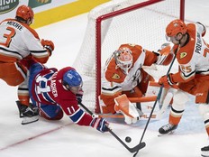 Anaheim goaltender Lukas Dostal makes a save as Canadiens winger Brendan Gallagher attempts a wraparound between Ducks' Ian Moore and Ryan Poehling (25) during third period in Montreal on Sunday.