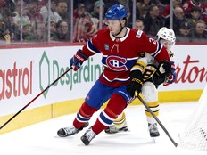 Canadiens winger Juraj Slafkovský ties up Boston Bruins' Fraser Minten during third period in Montreal on Tuesday.