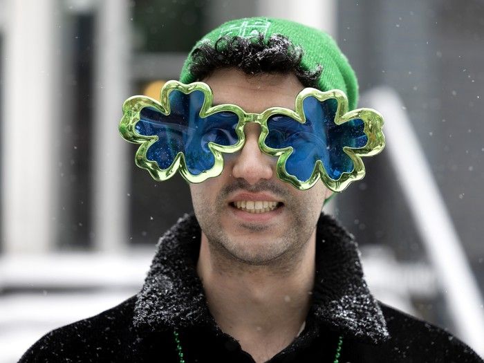 A spectator braves the steady snowfall to watch the St. Patrick’s Parade in Montreal on Sunday, March 22, 2026. A spectator braves the steady snowfall to watch the St. Patrick’s Parade in Montreal on Sunday, March 22, 2026.